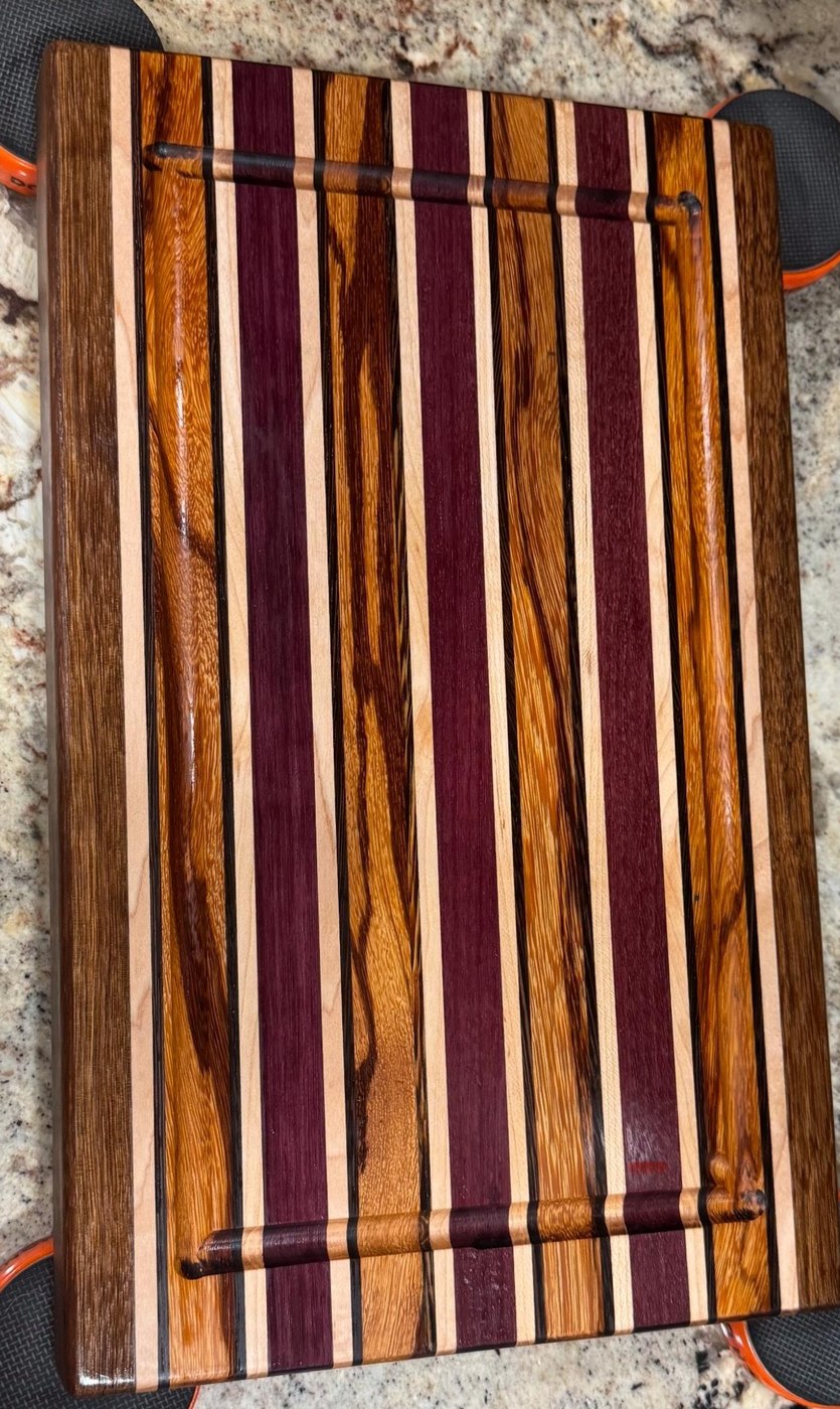 Actual WoodenYou premium laminated cutting board with purpleheart, maple, walnut and wenge strips and a routed juice groove